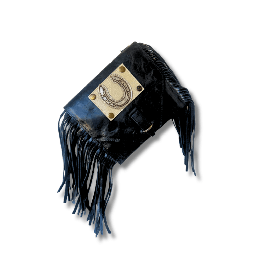 Black leather bag with fringes and a gold emblem on a white background